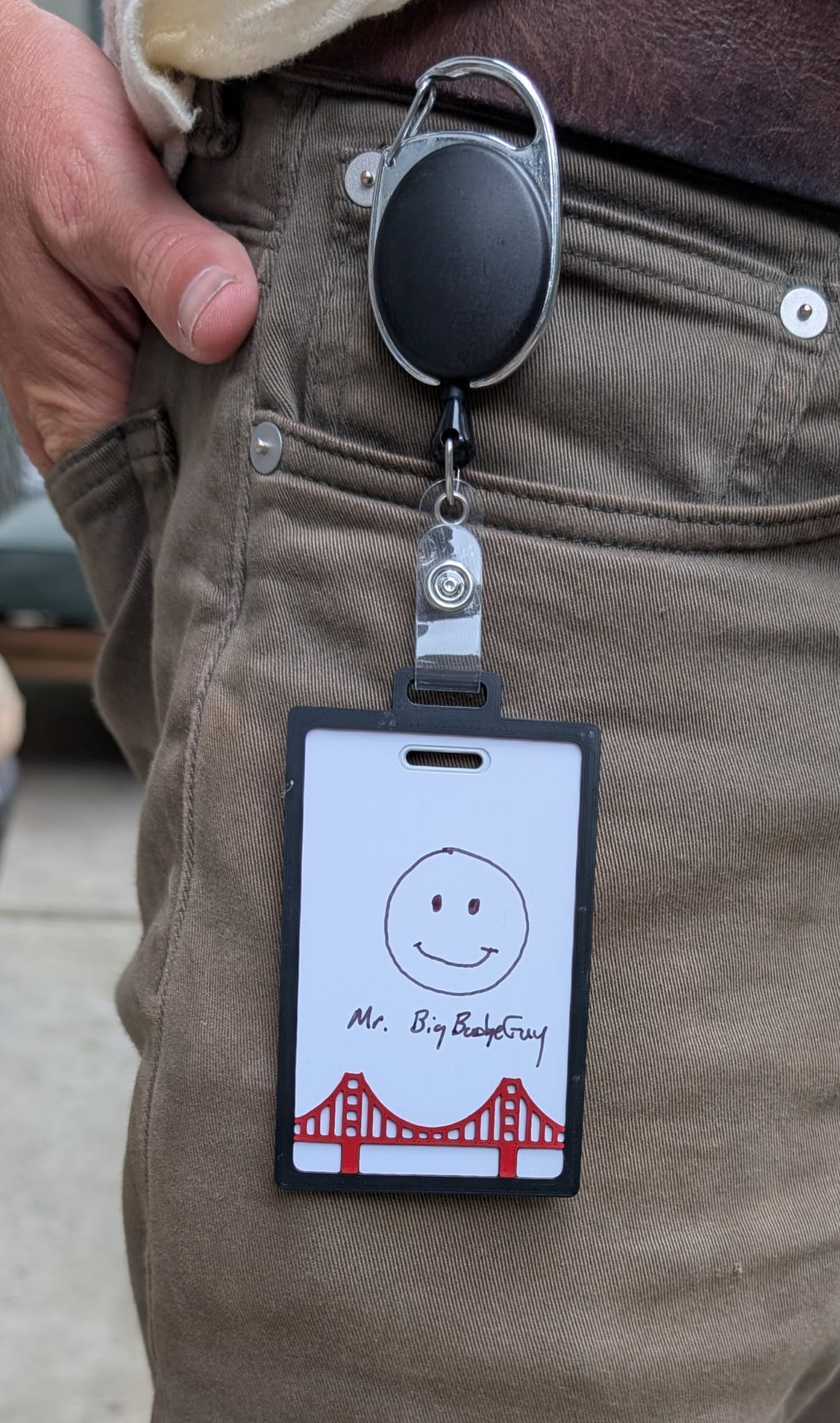 Badge holder clipped to pants with card